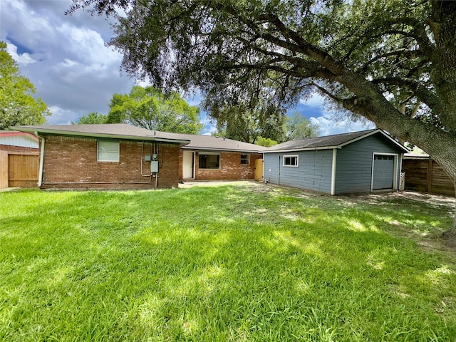 4310 Gallagher Dr, Houston, TX 77045 - back of property featuring brick siding, a detached garage, and an outbuilding