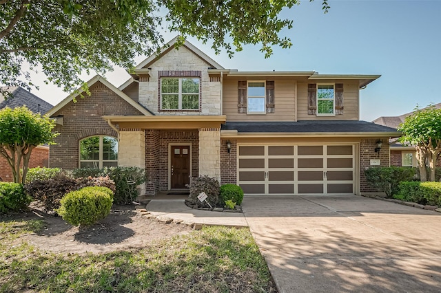 19547 Stetson Heights Ln, Richmond, TX 77407 - view of front of home featuring stone siding, a garage, driveway, and brick siding