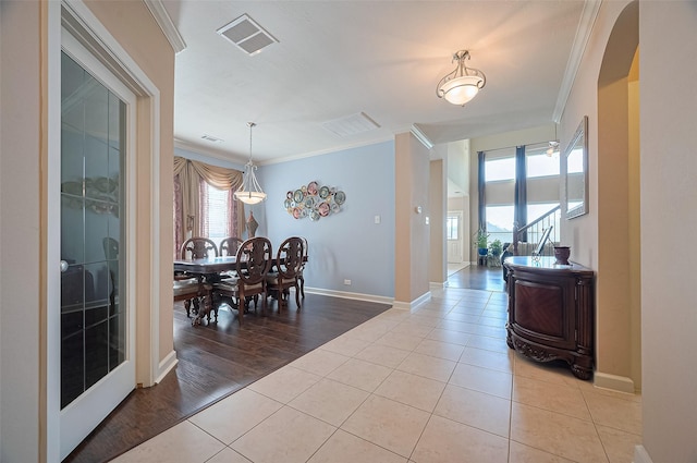 19547 Stetson Heights Ln, Richmond, TX 77407 - dining room with crown molding, light tile patterned flooring, and arched walkways