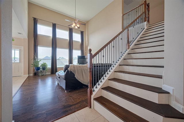 19547 Stetson Heights Ln, Richmond, TX 77407 - stairs featuring ceiling fan and wood finished floors