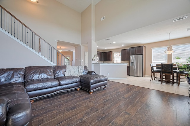 19547 Stetson Heights Ln, Richmond, TX 77407 - living area featuring light wood-style floors, plenty of natural light, stairway, recessed lighting, and a high ceiling
