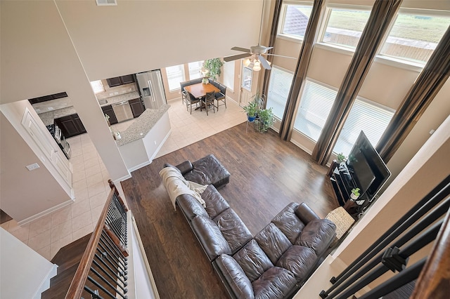 19547 Stetson Heights Ln, Richmond, TX 77407 - living room with a towering ceiling, ceiling fan, and dark wood-style floors