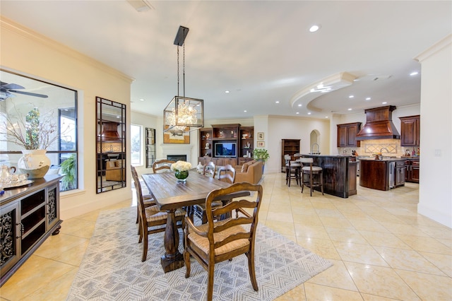 7615 San Clemente Point Ct, Katy, TX 77494 - dining room with light tile patterned floors, a fireplace, crown molding, recessed lighting, and ceiling fan