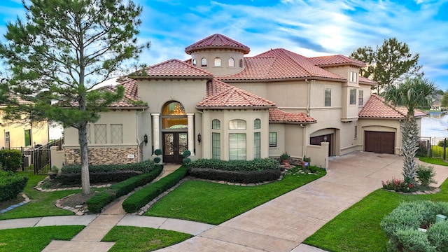 7615 San Clemente Point Ct, Katy, TX 77494 - mediterranean / spanish-style home featuring french doors, stucco siding, driveway, a tile roof, and an attached garage