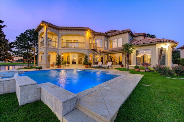 7615 San Clemente Point Ct, Katy, TX 77494 - rear view of property with a balcony, a patio area, a lawn, an outdoor pool, and stucco siding