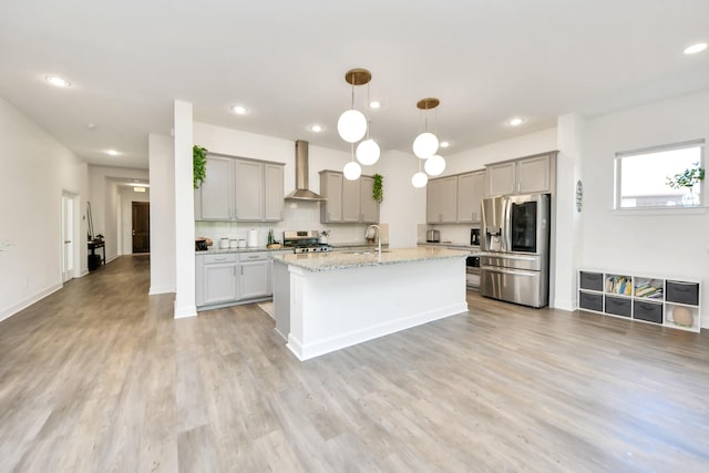 18334 Sunset Elm Dr, Cypress, TX 77433 - kitchen featuring wall chimney range hood, stainless steel appliances, gray cabinetry, recessed lighting, and light wood finished floors