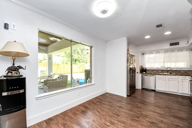 7726 Sorbete Dr, Houston, TX 77083 - kitchen featuring stainless steel appliances, crown molding, decorative backsplash, white cabinets, and dark wood-style floors