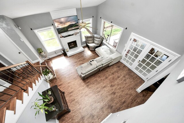 7726 Sorbete Dr, Houston, TX 77083 - living area featuring healthy amount of natural light, a large fireplace, wood finished floors, and high vaulted ceiling