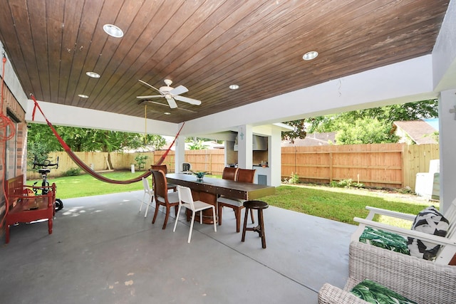 7726 Sorbete Dr, Houston, TX 77083 - fenced backyard featuring outdoor dining area, a patio, and a ceiling fan