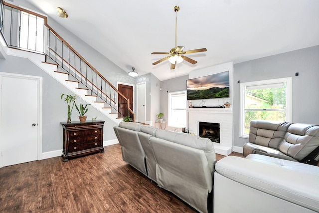 7726 Sorbete Dr, Houston, TX 77083 - living room featuring stairway, dark wood finished floors, ceiling fan, and a fireplace with raised hearth