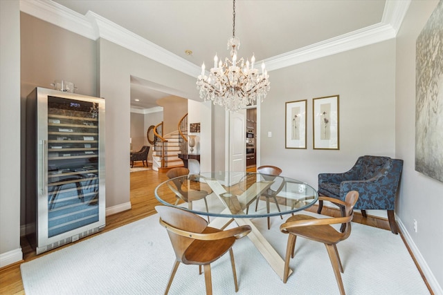 3926 Oberlin St, West University Place, TX 77005 - dining space with beverage cooler, stairs, ornamental molding, wood finished floors, and a chandelier