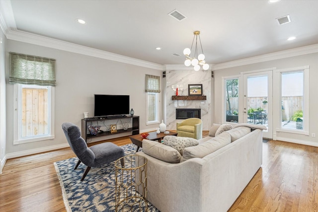 3926 Oberlin St, West University Place, TX 77005 - living area featuring ornamental molding, light wood finished floors, a high end fireplace, a chandelier, and recessed lighting