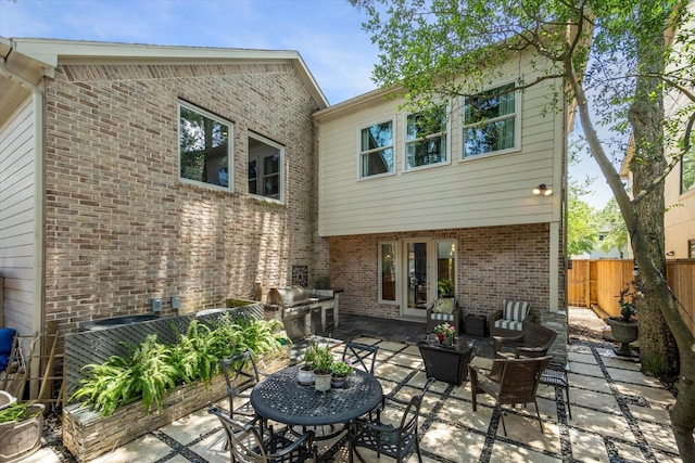 3926 Oberlin St, West University Place, TX 77005 - back of house featuring a patio, brick siding, an outdoor hangout area, and exterior kitchen