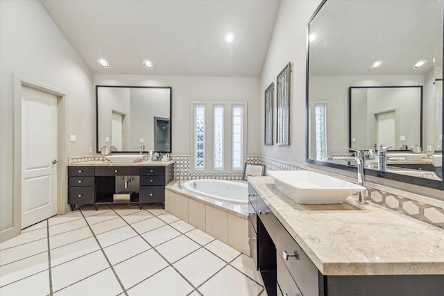 3926 Oberlin St, West University Place, TX 77005 - full bath with vaulted ceiling, two vanities, a bath, tile patterned flooring, and recessed lighting