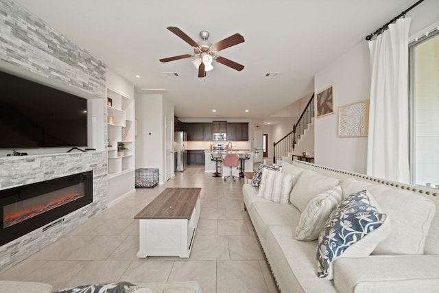 1205 Citruswood Trail Ln, Rosenberg, TX 77471 - living area with built in features, ceiling fan, a fireplace, light tile patterned floors, and recessed lighting