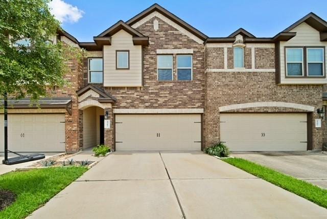1205 Citruswood Trail Ln, Rosenberg, TX 77471 - multi unit property featuring an attached garage, brick siding, and concrete driveway