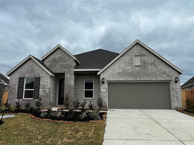 17918 Rillette Rd, Conroe, TX 77302 - view of front facade with a garage, concrete driveway, and brick siding