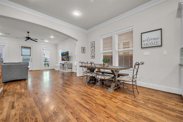 8720 Kempwood Dr, Houston, TX 77080 - dining room with arched walkways, wood finished floors, ornamental molding, ceiling fan, and recessed lighting