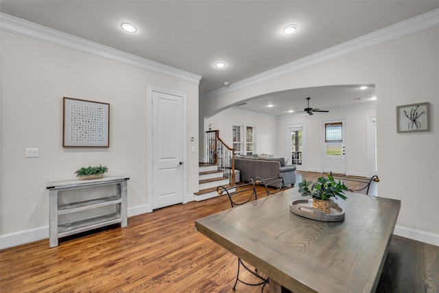 8720 Kempwood Dr, Houston, TX 77080 - dining area featuring arched walkways, ornamental molding, ceiling fan, wood finished floors, and stairway