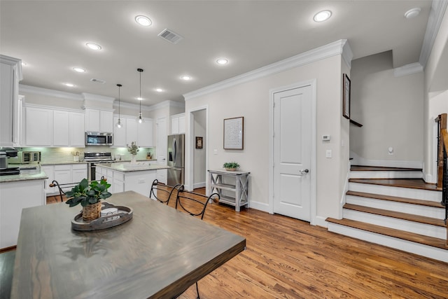 8720 Kempwood Dr, Houston, TX 77080 - dining room featuring crown molding, light wood-style floors, recessed lighting, and stairs