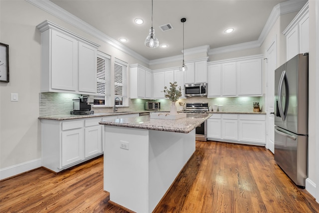 8720 Kempwood Dr, Houston, TX 77080 - kitchen featuring appliances with stainless steel finishes, white cabinetry, dark wood-type flooring, crown molding, and decorative backsplash