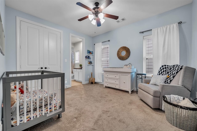 8720 Kempwood Dr, Houston, TX 77080 - bedroom featuring light carpet, a ceiling fan, a closet, and a crib