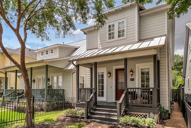 8720 Kempwood Dr, Houston, TX 77080 - view of front facade featuring a porch, a standing seam roof, and a metal roof