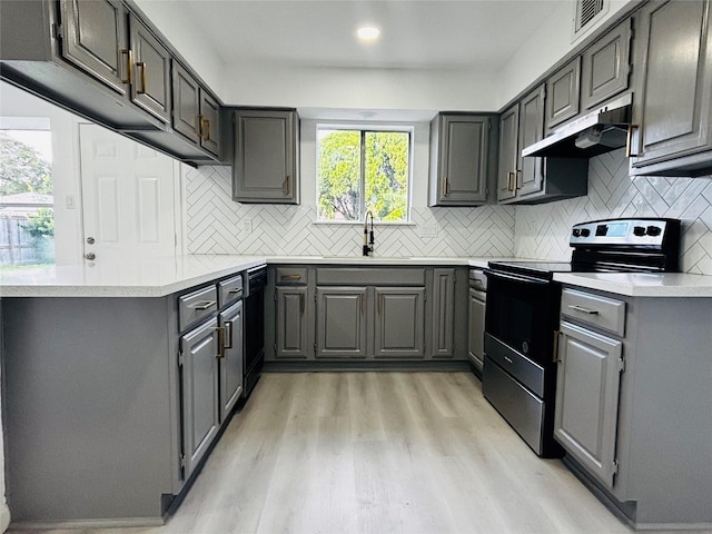 16246 Los Altos Dr, Houston, TX 77083 - kitchen with electric stove, under cabinet range hood, gray cabinetry, light wood-type flooring, and recessed lighting