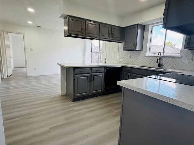 16246 Los Altos Dr, Houston, TX 77083 - kitchen featuring black dishwasher, light wood finished floors, a peninsula, tasteful backsplash, and recessed lighting
