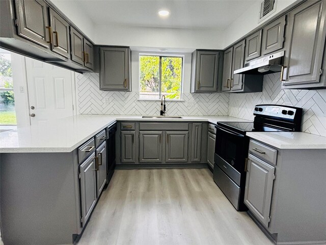 16246 Los Altos Dr, Houston, TX 77083 - kitchen with electric range, under cabinet range hood, gray cabinets, light wood-type flooring, and recessed lighting