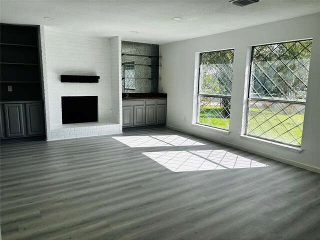16246 Los Altos Dr, Houston, TX 77083 - unfurnished living room featuring wood finished floors, a brick fireplace, and recessed lighting