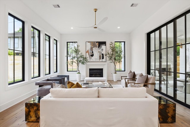 702 E 19th St, Houston, TX 77008 - living area with wood finished floors, a glass covered fireplace, a ceiling fan, and recessed lighting