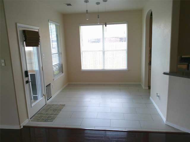 3307 Norma Ln, Pearland, TX 77584 - unfurnished dining area with arched walkways and baseboards