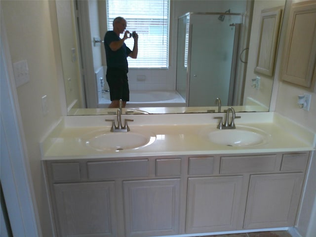 3307 Norma Ln, Pearland, TX 77584 - full bath featuring a shower with door, double vanity, and a tub to relax in
