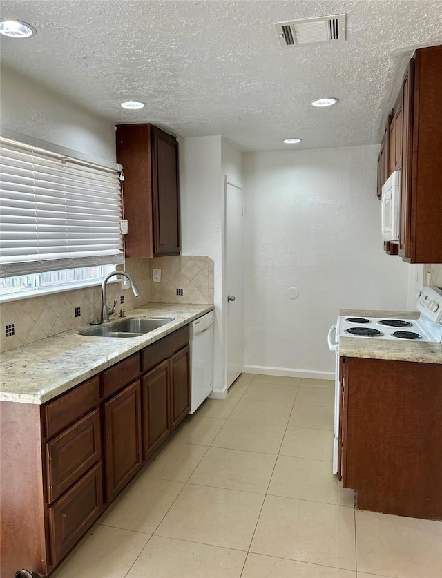 727 Doncrest St, Channelview, TX 77530 - kitchen featuring white appliances, tasteful backsplash, a textured ceiling, light countertops, and light tile patterned floors
