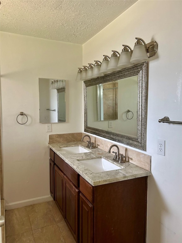 727 Doncrest St, Channelview, TX 77530 - full bath featuring double vanity, a textured ceiling, and tile patterned flooring