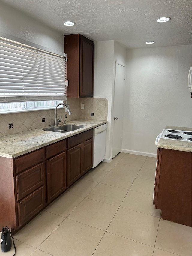 727 Doncrest St, Channelview, TX 77530 - kitchen with white dishwasher, a textured ceiling, decorative backsplash, light tile patterned flooring, and recessed lighting