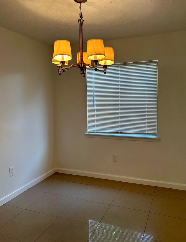 727 Doncrest St, Channelview, TX 77530 - unfurnished room featuring a chandelier, tile patterned floors, and a textured ceiling