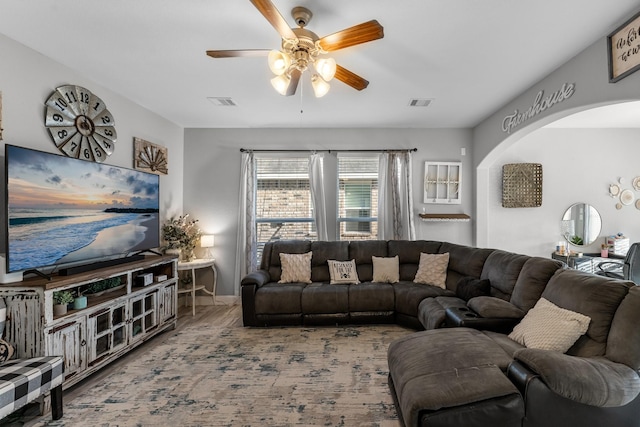 8315 Egret Bay Cir, Baytown, TX 77523 - living area featuring arched walkways, ceiling fan, and wood finished floors