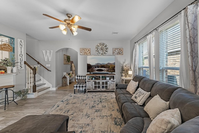 8315 Egret Bay Cir, Baytown, TX 77523 - living room with a ceiling fan, arched walkways, stairs, and wood finished floors