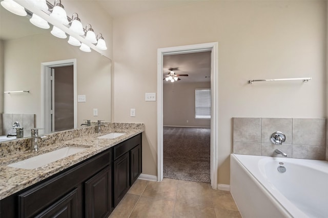1306 S Maple Dr, Katy, TX 77493 - bathroom featuring double vanity, a bath, ceiling fan, and tile patterned flooring