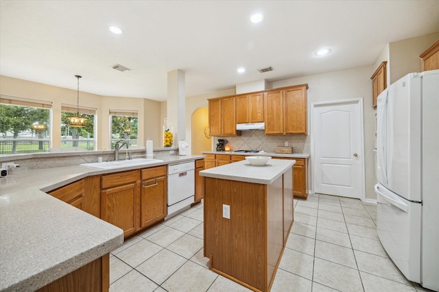 17326 Mesquite Brush Ln, Houston, TX 77095 - kitchen featuring white appliances, under cabinet range hood, backsplash, light countertops, and recessed lighting