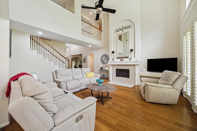 17326 Mesquite Brush Ln, Houston, TX 77095 - living area with a towering ceiling, arched walkways, wood finished floors, ceiling fan, and stairway