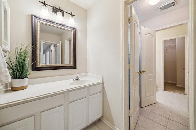 17326 Mesquite Brush Ln, Houston, TX 77095 - bathroom featuring vanity, tile patterned floors, and a walk in closet