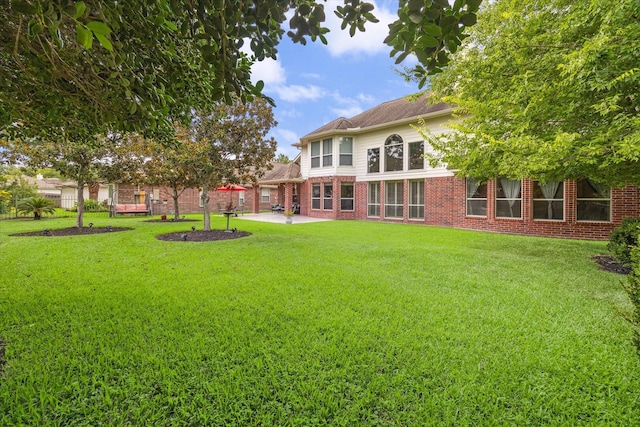17326 Mesquite Brush Ln, Houston, TX 77095 - view of green lawn featuring a patio area