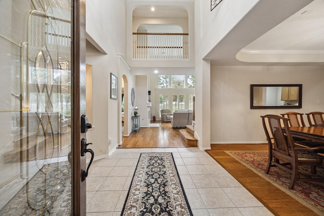 17326 Mesquite Brush Ln, Houston, TX 77095 - foyer entrance featuring light tile patterned flooring, crown molding, and arched walkways