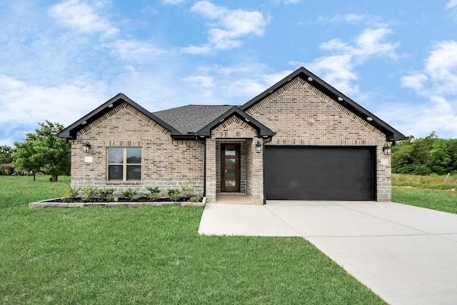 601 Lily St, Waller, TX 77484 - french country style house with brick siding, a garage, driveway, and a front lawn