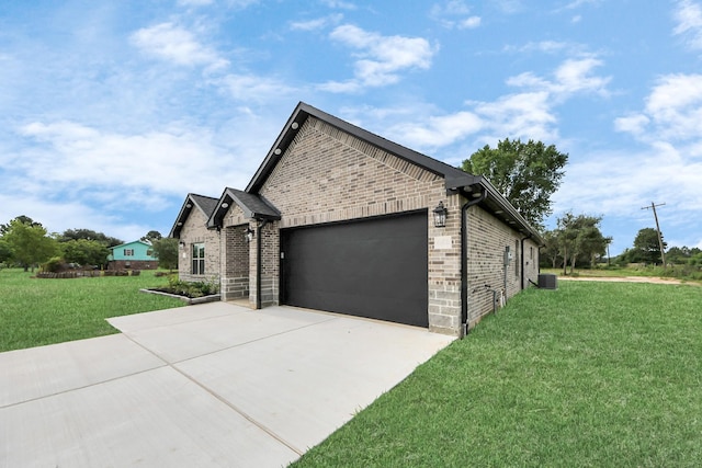 601 Lily St, Waller, TX 77484 - view of home's exterior with driveway, brick siding, an attached garage, and a lawn