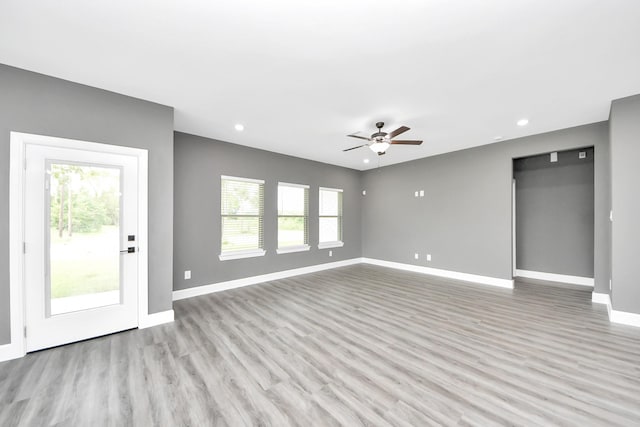601 Lily St, Waller, TX 77484 - unfurnished living room with a ceiling fan, recessed lighting, and light wood-style floors