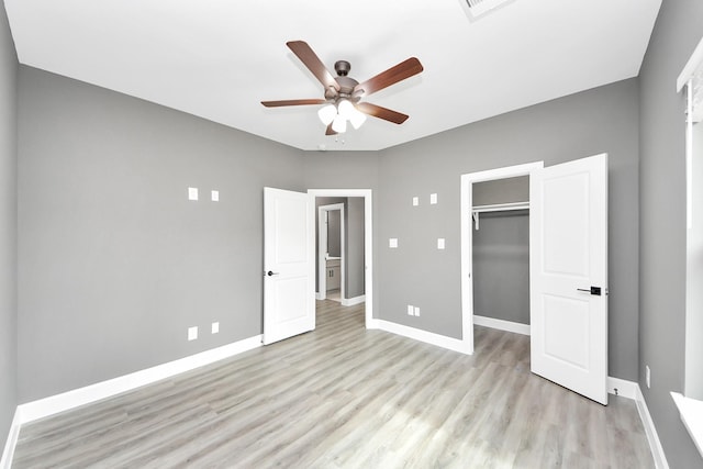 601 Lily St, Waller, TX 77484 - unfurnished bedroom with light wood-type flooring, a walk in closet, a ceiling fan, and a closet